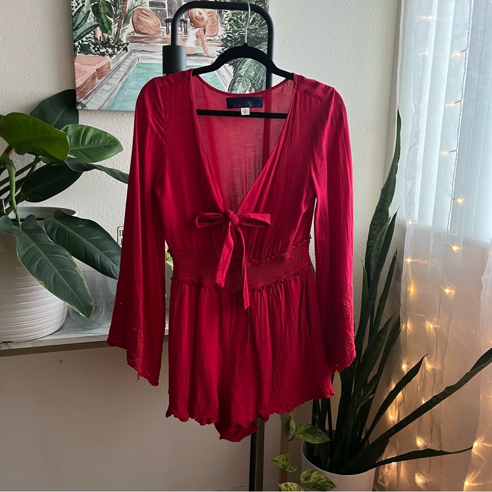 Fun Red long sleeve romper with bow and peek a boo front